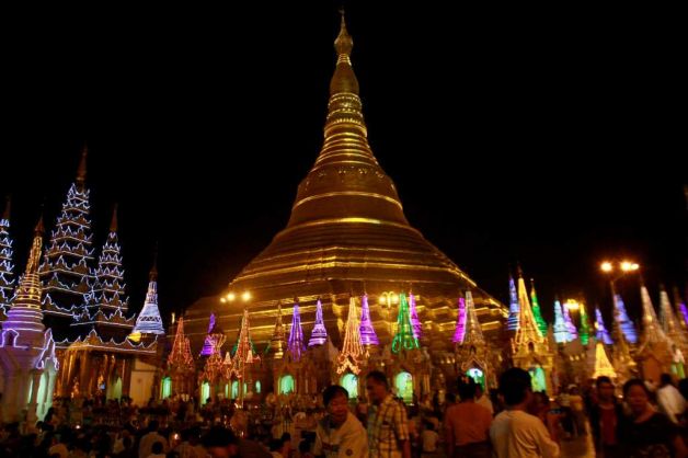 Description: Buddhist devotees prepare to cerebrate the 2,600 anniversary of Myanmar's land mark Shwedagon Pagoda's establishment in Yangon, Myanmar Tuesday, Feb. 21, 2012. Vast crowds were gathering Wednesday at Myanmar's most sacred Buddhist shrine to celebrate a festival banned for more than 20 years under the former military government. Photo: Khin Maung Win / AP