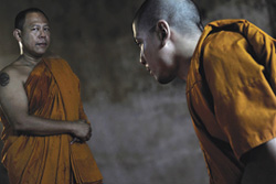 Description: [younger Thai monk bows to senior monk]