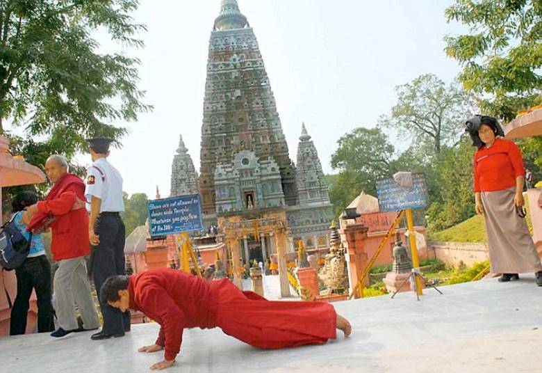 Monks worship in front of Mahabodhi Temple in Bodh Gaya, which is the holiest place in Buddhism
