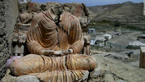 Description: A Buddhist statue overlooks a Chinese government-owned mining compound in Logar province, Afghanistan. Mes Aynak, a 2,600-year-old Buddhist site, could be destroyed in December to create a massive copper mine.
