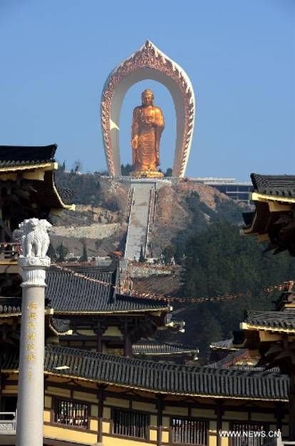The Donglin Buddha statue is seen at the Donglin Temple in Xingzi County of Jiujiang City, east China's Jiangxi Province, March 6, 2013. The bronze statue of Amitabha Buddha, which is 48 meters in height, is believed to be the tallest of its kind in the world. The project, with the total cost of about 1 billion yuan (161 million U.S. dollars), has been basically completed. It was totally funded by private donations. (Xinhua/Song Zhenping) 