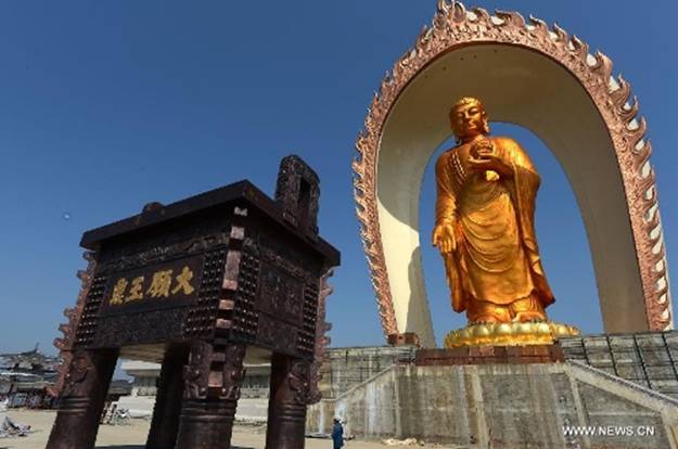 The Donglin Buddha statue is seen at the Donglin Temple in Xingzi County of Jiujiang City, east China's Jiangxi Province, March 6, 2013. The bronze statue of Amitabha Buddha, which is 48 meters in height, is believed to be the tallest of its kind in the world. The project, with the total cost of about 1 billion yuan (161 million U.S. dollars), has been basically completed. It was totally funded by private donations. (Xinhua/Song Zhenping)  