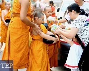 Description: For older Thais the sight of novice monks during the Thai school break is a comforting anchor to  traditions