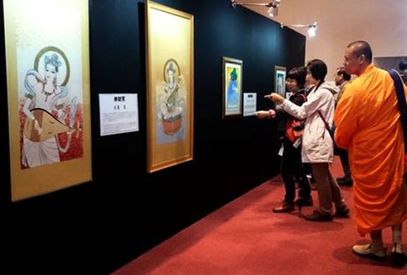 Description: Visitors to Zojoji temple in Tokyo admire works by manga artists devoted to the theme of Buddha in an exhibition that continues until May 13. (Louis Templado) 