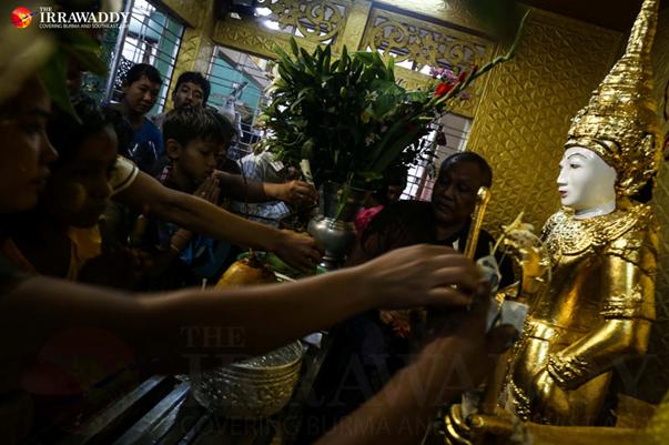 People make offerings to the statue of Kamae Phyin Bo Bo Gyi . (Photo: JPaing / The Irrawaddy)