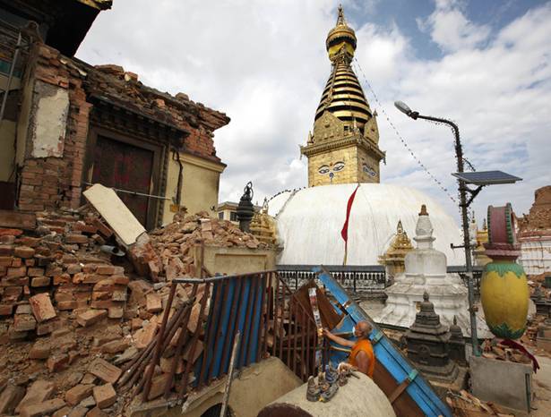 A Buddhist monk picks through a damaged monastery near the Swayambhunath stupa.