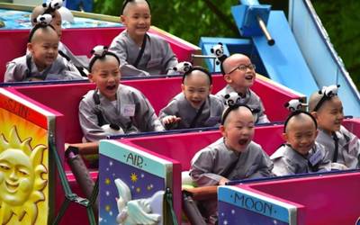  Young South Korean novice monks ride on a 'Magic Swing' 