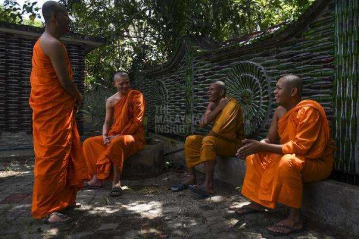 Monks resting at Wat Charok Padang, Malaysia. Photo by Seth Akmal. From themalaysianinsight.com