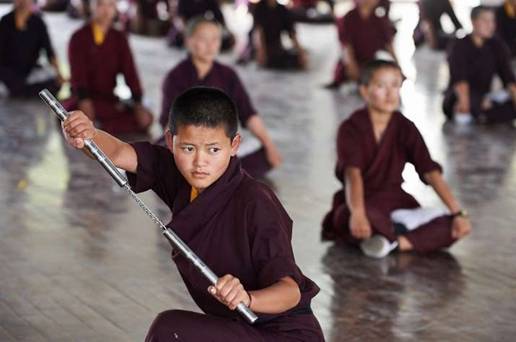 A young nun during martial arts practice. Image courtesy of Olivier Adam