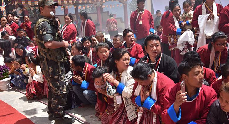 Buddhist followers wait for exiled Tibetan spiritual leader the Dalai Lama at Urgelling Monastery, the birthplace of the 6th Dalai Lama, in the district of Tawang in India's north-eastern state of Arunachal Pradesh on April 9, 2017