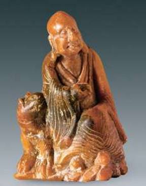 An 8.2 centimeter statue of an <i>arhat</i> beside a tiger, carved from agalmatolite. From livescience.com