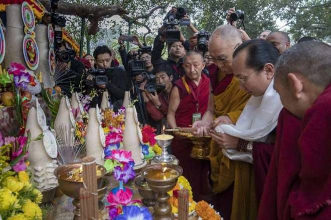 The Dalai Lama lights a lamp near the Bodhi Tree. From dalailama.com