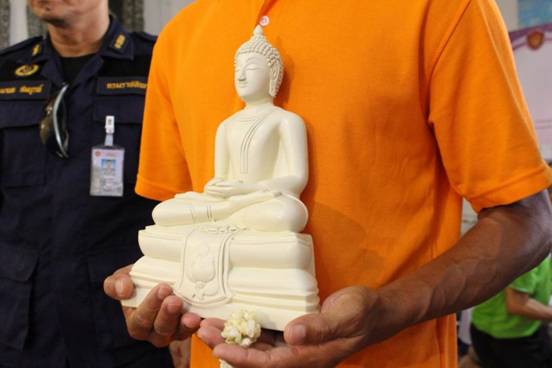 An inmate presents his masterpiece during a recent press conference focusing on the Corrections Department’s project encouraging prisoners to sculpt Buddha statues.