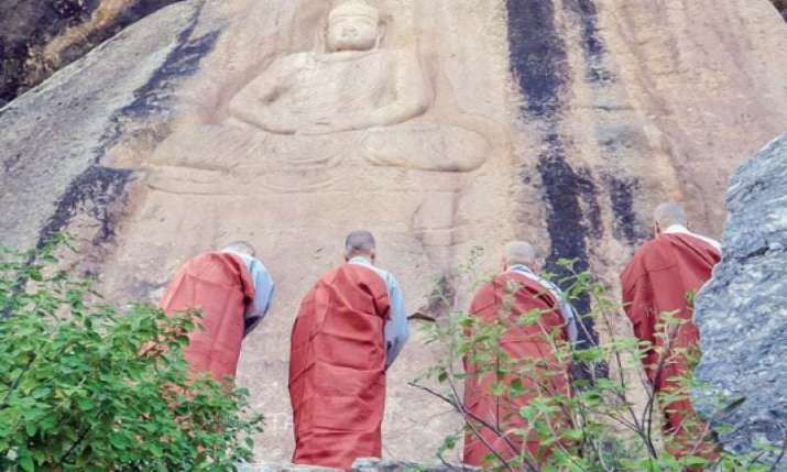 South Korean monks pay respect at a rock carving of the Buddha in Jahanabad, Pakistan, on Wednesday. From dawn.com