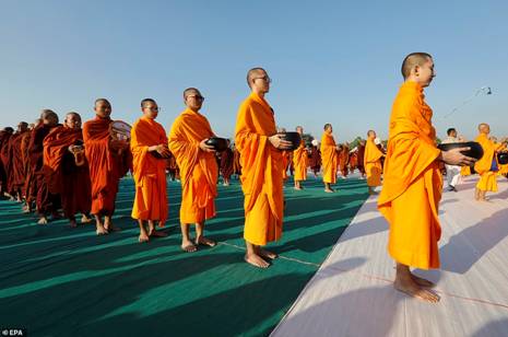 Description: Myanmar and Thai Buddhist monks queuing up to offer alms - the giving to others as an act of virtue - in Mandalay, Myanmar