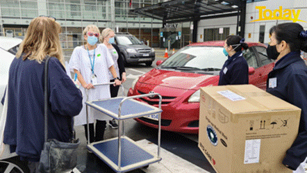 Description: Grateful healthcare workers receive a delivery of essential supplies.
