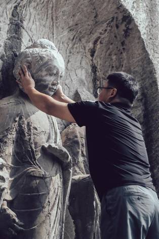 Description: Buddhas head restored on statue with 3D tech 