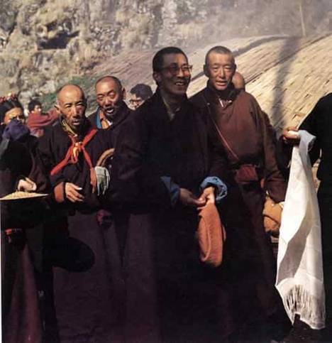Description: The Dalai Lama arrives in India and is greeted with a khatag or offering scarf. On the right, behind him is his Lord Chamberlain, Phala Thupten Woden. On the left are the Simpon Khenpo (Master of the Robes) and the Chopen Khenpo (Master of the Ritual) 