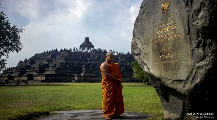 Buddhist monk stands in front of Borobudur Temple after pradakshina ritual at the Borobudur Temple in Central Java, on May 26, 2021. (JG Photo/Yudha Baskoro)