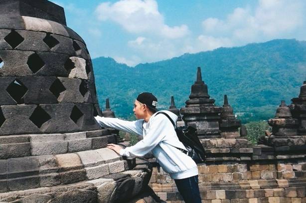 Indonesian student Christopher Reinhart touches a Buddhist stupa at the Borobudur temple in Central Java: Photo: Handout via Christopher Reinhart